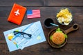 Gastronomical tourism with american flag, passport, tickets, map, burgers, chips, drink on wooden background top view Royalty Free Stock Photo