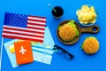 Gastronomical tourism with american flag, passport, tickets, map, burgers, chips, drink on blue background top view Royalty Free Stock Photo