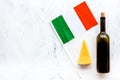 Gastronomical tourism. Italian food symbols. Italian flag, cheese parmesan and bottle of red wine on white background Royalty Free Stock Photo