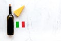 Gastronomical tourism. Italian food symbols. Italian flag, cheese parmesan and bottle of red wine on white background Royalty Free Stock Photo