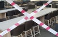 Gastronomy lockdown due to corona epidemic, closed restaurant terrace,chairs, tables and barrier tape, symbolic