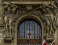 stone statues as supports to the bank entrance Royalty Free Stock Photo