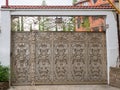 A gate with an elaborate wrought iron decor of many monograms with patina