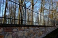 Gate and fence at the castle in the autumn sun. the lattice ending the end of the wall protected thieves from improper intruders. Royalty Free Stock Photo