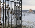 Gate in a snowy field in front of a winery
