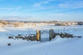 Gate at a stone wall covered with snow Royalty Free Stock Photo