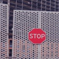 A gate with a stop sign at the entrance to the construction site. Closed due to the coronavirus pandemic building construction Royalty Free Stock Photo