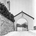 The gate to the baroque church of the village of Alvaneu in Switzerland shot with black and white analogue film technique in