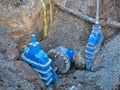 Gate valves in a dug trench in a pavement - part of a water supply network in the UK