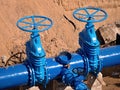 Gate valves underground, water pipeline valve on a blue pipeline after reconstruction. Royalty Free Stock Photo