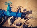 Gate valves underground, water pipeline valve on a blue pipeline after reconstruction. Royalty Free Stock Photo