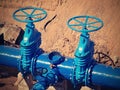 Gate valves underground, water pipeline valve on a blue pipeline after reconstruction. Royalty Free Stock Photo