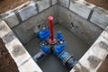 Gate valves in valve pit of the underground piping networks. Laying water system pipeline at construction site. Water supply Royalty Free Stock Photo