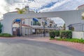 Gated entrance at a neighborhood in Huntington Beach under cloudy blue sky