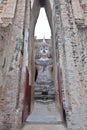 Gated entrance to the assembly hall mondop at Wat Si Chum, with view of its Giant Buddha, Sukhothai Historical Park, Thailand