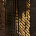 Gates with bars and their shadows on te wall Royalty Free Stock Photo