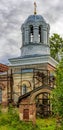 Gates and pillar-shape bell tower of large Orthodox Church of St. Nicholas the Partially destroyed large Orthodox Church