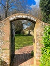 Gates through Rudyard Kipling's a walled English Landscaped Garden Royalty Free Stock Photo