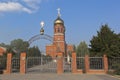 Gates to the Church of the Holy Great Martyr and Healer Panteleimon in the rays of the setting sun in the city of Slavyansk-on-