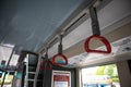 Interior inside of bus showing drop down handle strap for passengers to hold Royalty Free Stock Photo