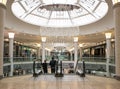 Interior inside of modern shopping centre mall with escalators and luxury chandelier Royalty Free Stock Photo