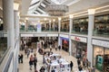 Interior inside of modern shopping centre mall with luxury chandelier and people Royalty Free Stock Photo