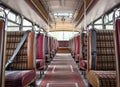 Interior inside of old classic vintage bus showing isle, seating and windows with added seat belts