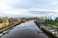 Gateshead Millennium Bridge crossing River Tyne in Gateshead, with a view of Newcastle upon Tyne, UK Royalty Free Stock Photo