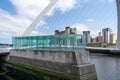 Gateshead Millennium Bridge is a pedestrian and cyclist tilt bridge spanning the River Tyne