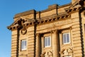 Impressive architecture of a former Lloyds Bank with golden lettering on exterior