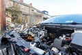 A broken down car with bonnet removed awaiting repair