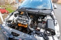 A broken down car with bonnet removed awaiting repair