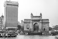 The Gateway of India and boats in the background Taj Mahal Hotel, Mumbai, India. Royalty Free Stock Photo