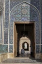 Old man passes through the gate of mosque, Yazd, Iran.