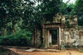 A gateway to one of the Bayon temples in Angkor, Siem Reap, Cambodia surrounded by a lush green forest - UNESCO World Heritage Royalty Free Stock Photo