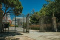 Gateway and wrought iron fence on garden with trees in Madrid Royalty Free Stock Photo