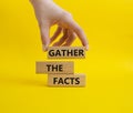 Gather the facts symbol. Wooden blocks with words Gather the facts. Beautiful yellow background. Businessman hand. Business and Royalty Free Stock Photo