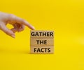 Gather the facts symbol. Wooden blocks with words Gather the facts. Beautiful yellow background. Businessman hand. Business and Royalty Free Stock Photo