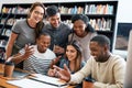 Gathered for the good of their education. a group of young students working on an assignment together in a college Royalty Free Stock Photo