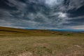 Gathering dramatic stormclouds over the green valley Royalty Free Stock Photo