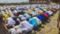 A gathering of Muslim men and children bowing down and offering Namaz prayers on the occasion of Eid`Al-Fitr Royalty Free Stock Photo