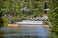 The Gathering Place - Award winning public park in Tulsa OK USA - Wooden deck with chairs beside pond with rowboats filled with