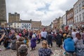 A gathering of protesters kneel at a Black Lives Matter protest in Richmond, North Yorkshire, with Richmond Castle in the Royalty Free Stock Photo