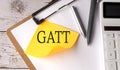 GATT word on a yellow sticky with calculator, pen and clipboard Royalty Free Stock Photo