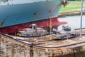 GATUN, PANAMA - MAY 29, 2016: Electric locomotives, known as mules guiding a container ship through Gatun Locks, part of Royalty Free Stock Photo