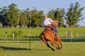 Gaucho rides a horse race on a track at a Criolla Festival in Uruguay, South America, also been seen in Argentina Royalty Free Stock Photo