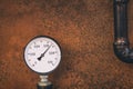 Gauge for measuring pressure in the gas pipeline system grunge design on iron rusted background base Royalty Free Stock Photo