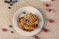 Gaufre with wild berries on a plate