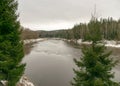 Gaujas national park. View of the river Gauja in December with light snow and cloudy sky Royalty Free Stock Photo