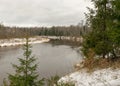 Gaujas national park. View of the river Gauja in December with light snow and cloudy sky Royalty Free Stock Photo